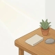 Houten hoekbureau met potplant, linnen stofstaal en stenen sample in warm eiken en saliegroen, gefotografeerd van bovenaf.