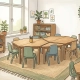 Lichte Nederlandse klashoek met hexagonale tafels en pastelkleurige stapelstoelen bij een raam dat zacht daglicht verspreidt.